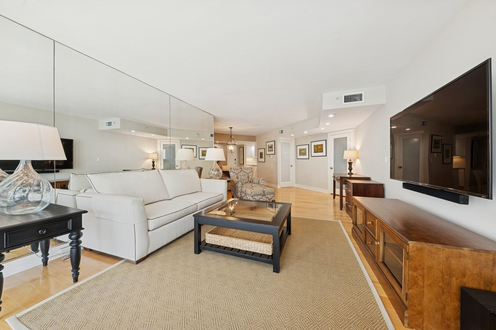 3000 North Ocean Drive, Unit 18G Singer Island, FL 33404 - Photo 3 of 46 a living room with furniture and a flat screen tv
