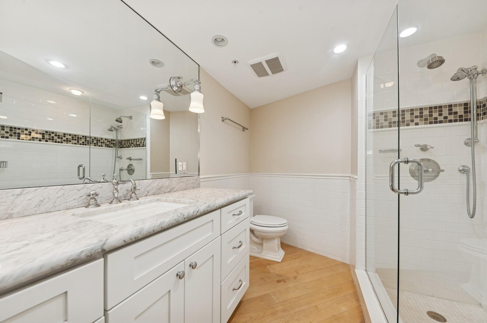 3000 North Ocean Drive, Unit 18G Singer Island, FL 33404 - Photo 7 of 46 a bathroom with a granite countertop sink a toilet and a shower
