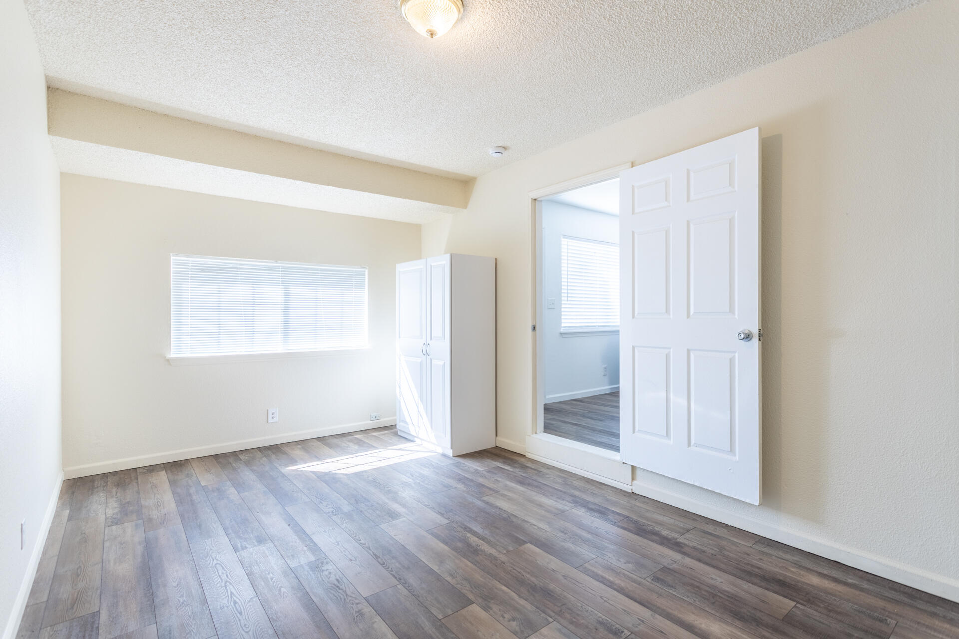 3252 Daisy Street Anderson, CA 96007 - Photo 11 of 20 an empty room with wooden floor and windows