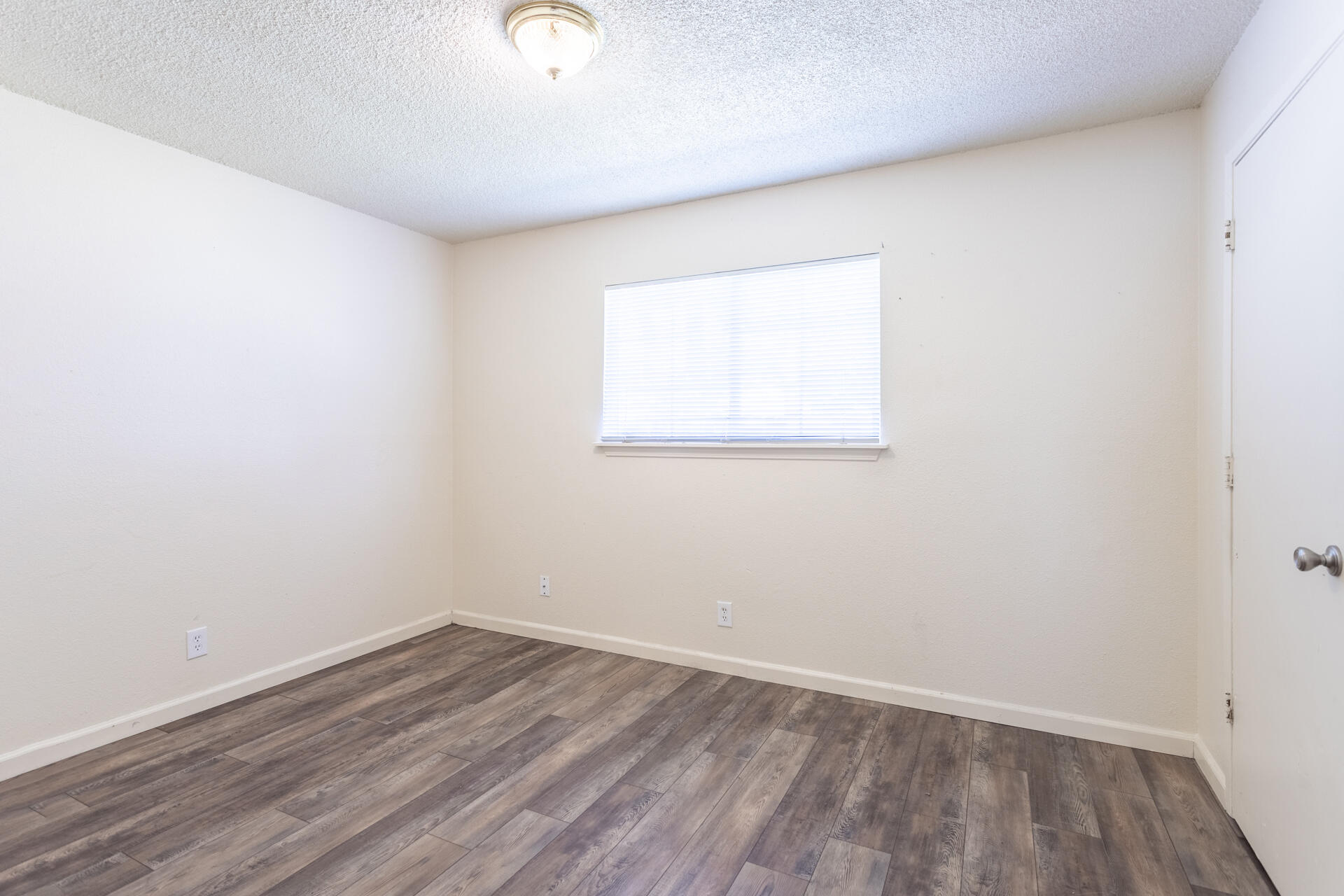 3252 Daisy Street Anderson, CA 96007 - Photo 14 of 20 an empty room with wooden floor and windows