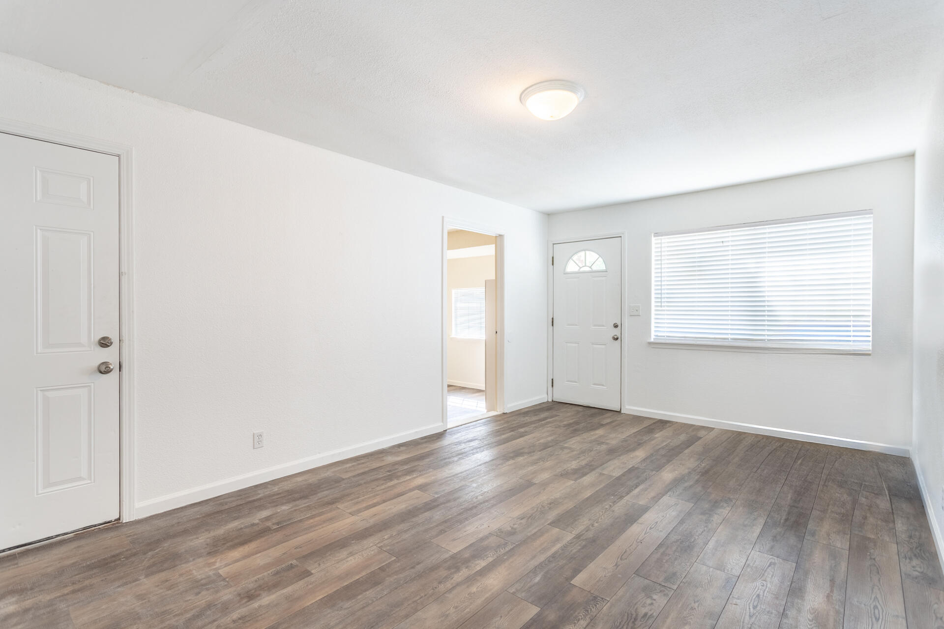 3252 Daisy Street Anderson, CA 96007 - Photo 5 of 20 a view of an empty room with wooden floor and a window