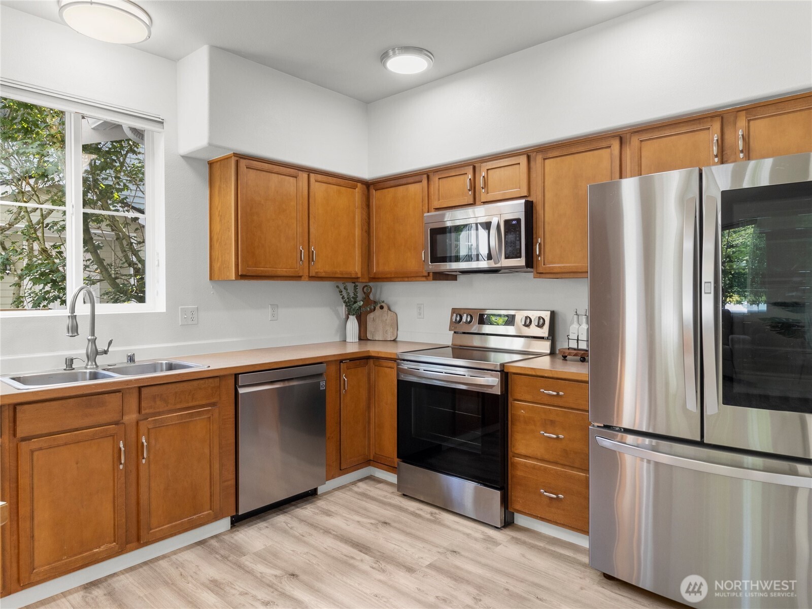 1331 Rowan Court DuPont, WA 98327 - Photo 11 of 31 a kitchen with stainless steel appliances granite countertop a refrigerator sink and stove