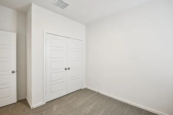 an empty room with closet area