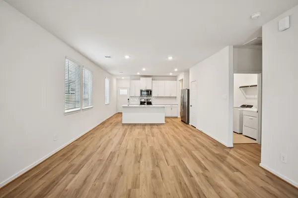 a view of a kitchen with wooden floor