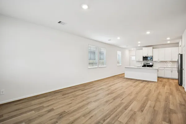 a view of kitchen with wooden floor and large window