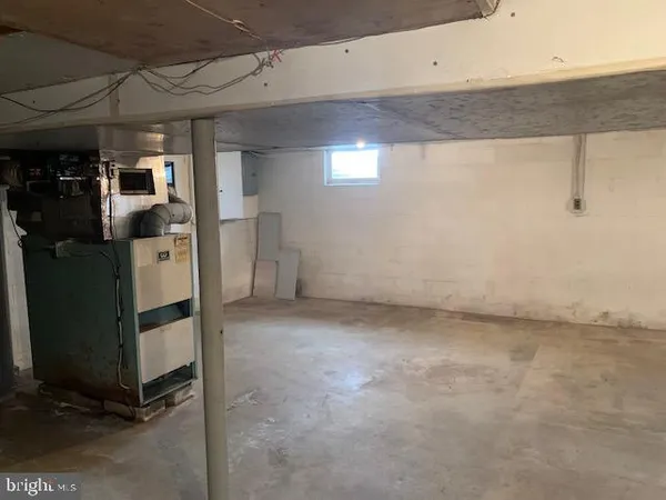 a view of a refrigerator in kitchen and utility room
