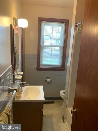 a bathroom with a sink toilet and mirror