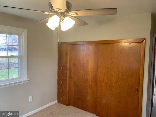 a view of a chandelier fan and fire place