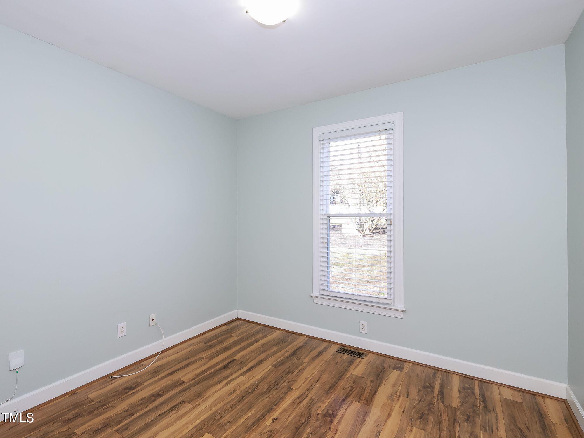 2604 Dahlgreen Road Raleigh, NC 27615 - Photo 29 of 40 a view of an empty room with wooden floor and a window
