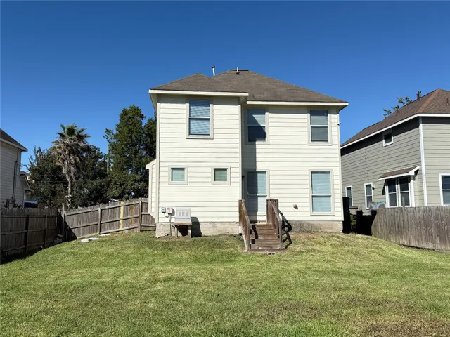 a view of a backyard with a barbeque grill and plants