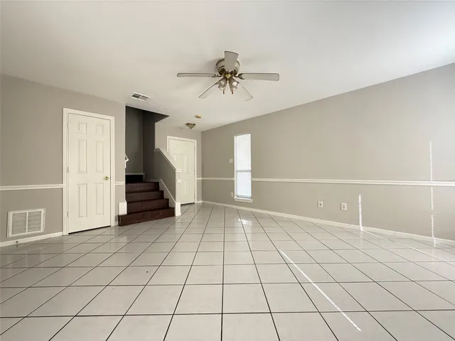 a view of an empty room and staircase