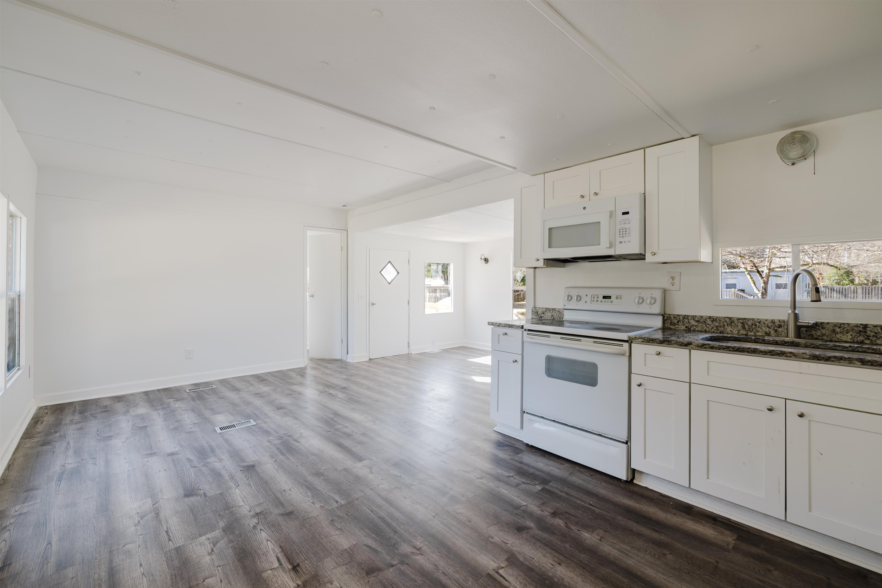 1805 Cactus Drive Loris, SC 29569 - Photo 16 of 31 Kitchen featuring white cabinets, white appliances, dark stone countertops, and dark wood-style flooring