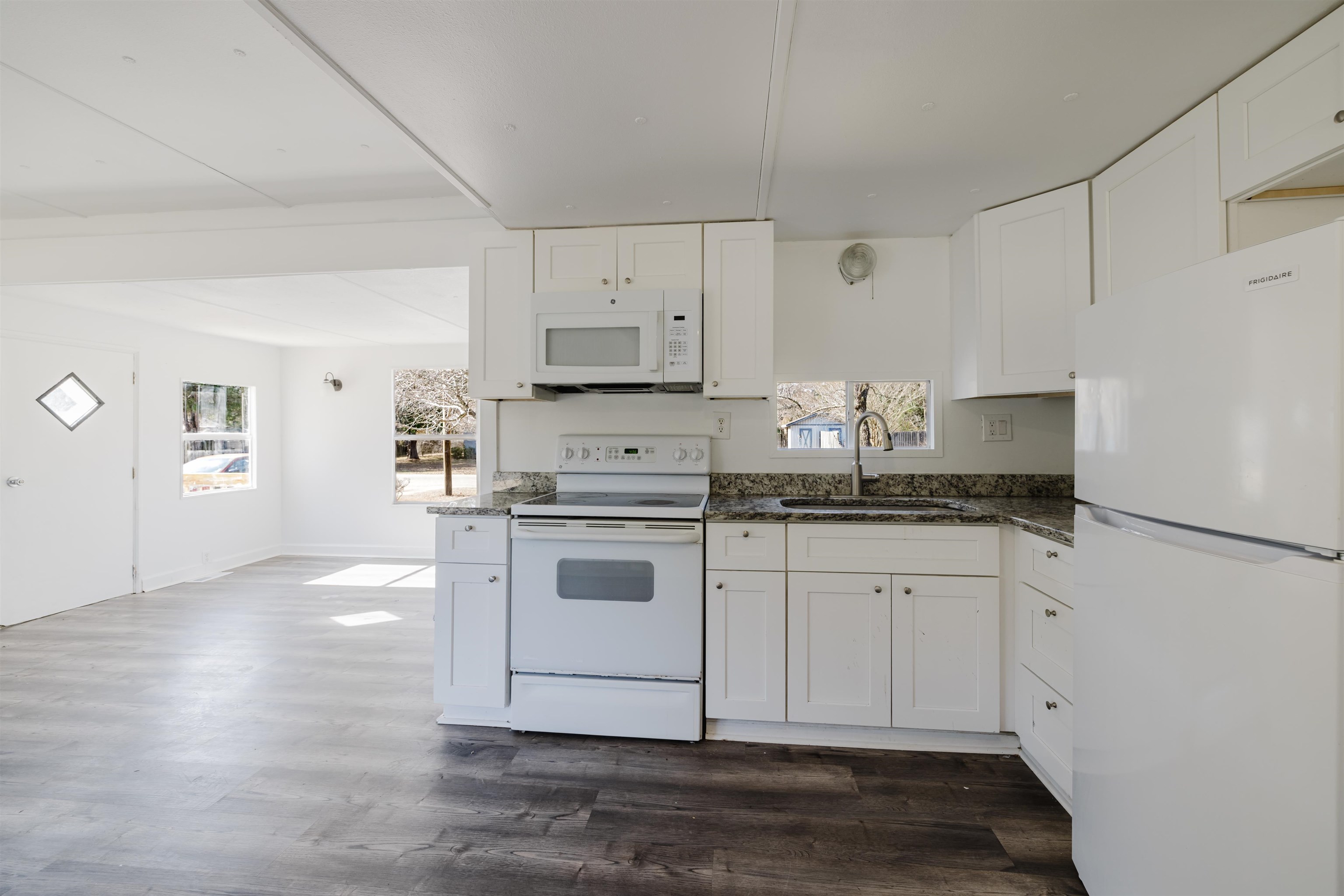 1805 Cactus Drive Loris, SC 29569 - Photo 24 of 31 Kitchen with white appliances, white cabinets, dark stone countertops, and dark wood-type flooring