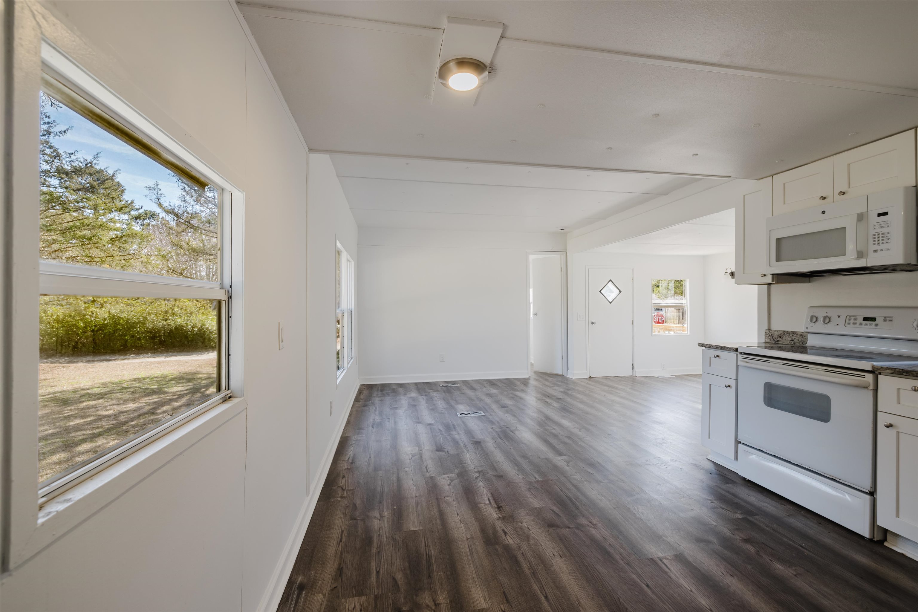 1805 Cactus Drive Loris, SC 29569 - Photo 8 of 31 Kitchen featuring white appliances, white cabinetry, and dark wood-style flooring