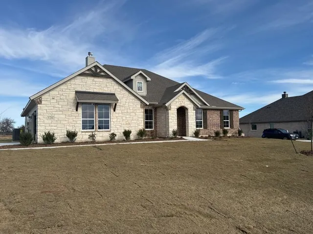 a view of a house with a yard and garage