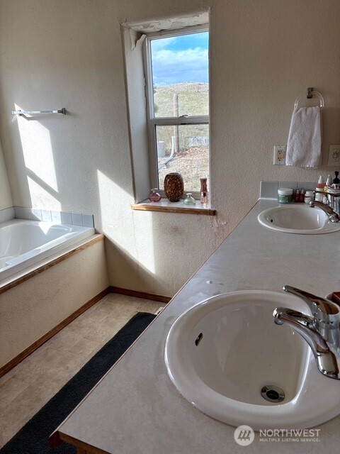 1579 Pine Creek Road, Unit A Tonasket, WA 98855 - Photo 15 of 24 a bathroom with a sink and a window