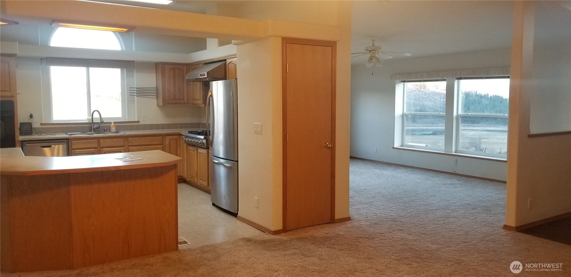 1579 Pine Creek Road, Unit A Tonasket, WA 98855 - Photo 16 of 24 a view of a kitchen with a fridge and wooden floor