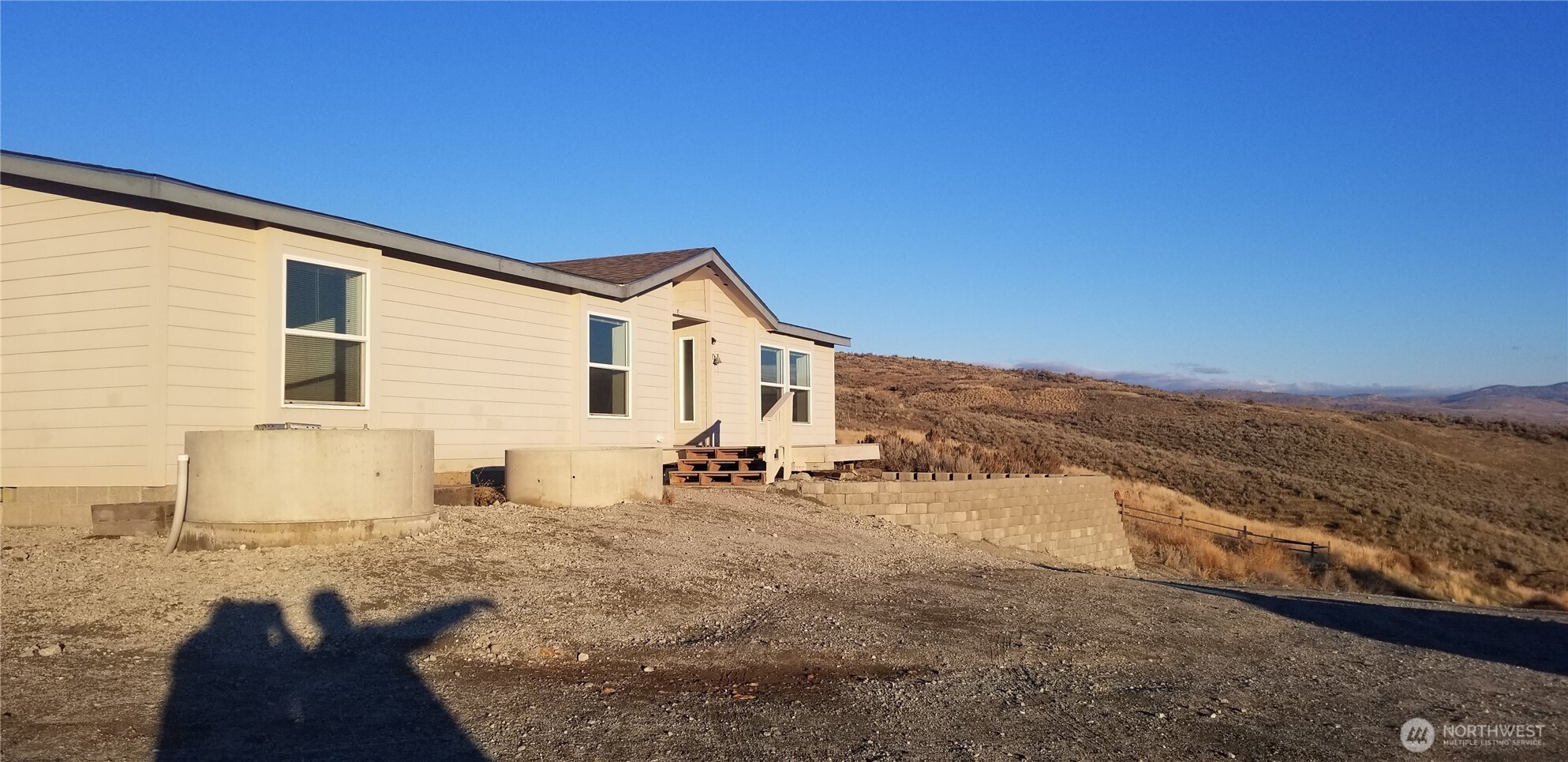 1579 Pine Creek Road, Unit A Tonasket, WA 98855 - Photo 2 of 24 a view of a house with a yard