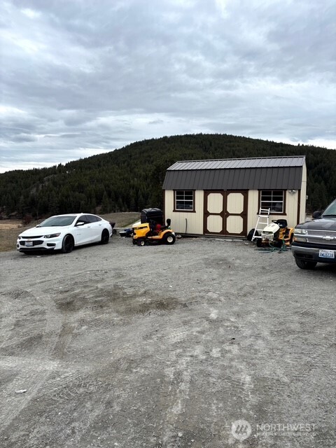 1579 Pine Creek Road, Unit A Tonasket, WA 98855 - Photo 5 of 24 a view of parking space with parked cars