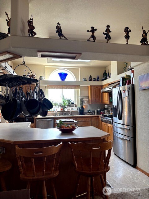 1579 Pine Creek Road, Unit A Tonasket, WA 98855 - Photo 8 of 24 a kitchen with a table chairs stove and refrigerator