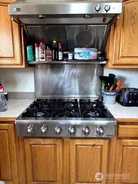 1579 Pine Creek Road, Unit A Tonasket, WA 98855 - Photo 10 of 24 a stove top oven sitting inside of a kitchen