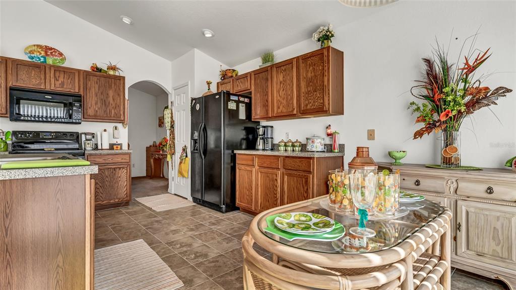 1153 Legatto Loop Dundee, FL 33838 - Photo 16 of 48 a kitchen with stainless steel appliances granite countertop a refrigerator and a stove top oven