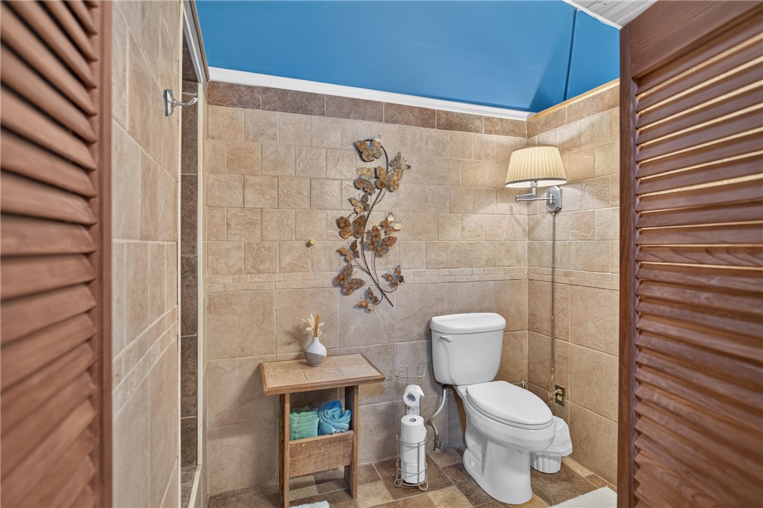 351 River Road Westminster, SC 29693 - Photo 26 of 50 Well-appointed bathroom showcasing tiled walls and a functional toilet area.