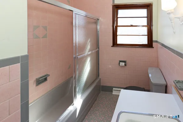 a bathroom with a bathtub and toilet