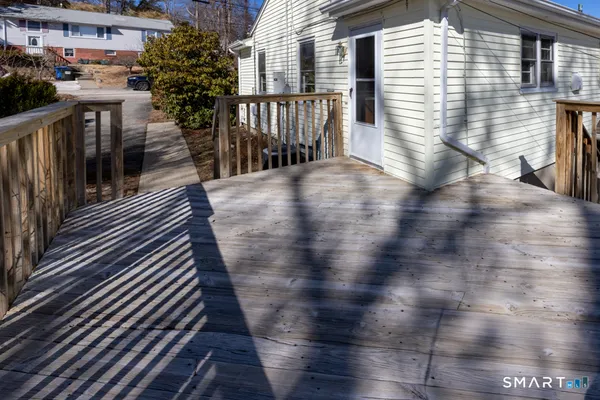 a view of a balcony with wooden floor