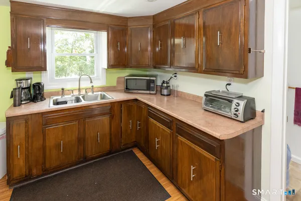 a kitchen with a sink cabinets and window
