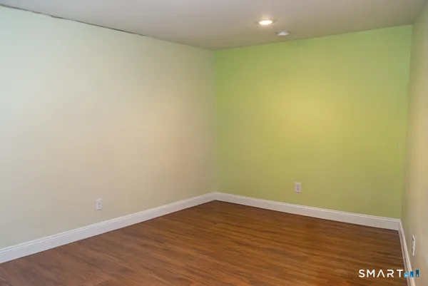 a view of an empty room with wooden floor