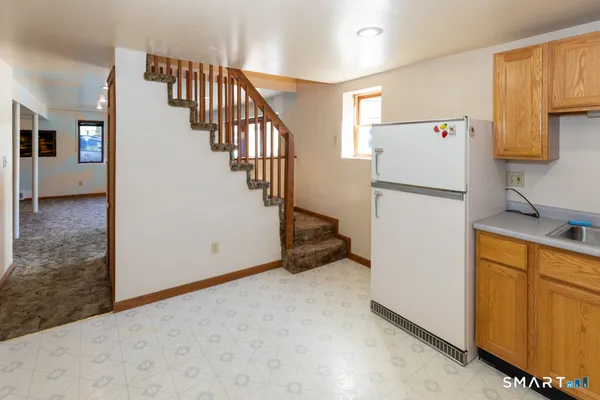 a kitchen with a sink a stove a refrigerator and cabinets