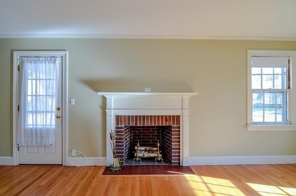 77 West Central Street Natick, MA 01760 - Photo 14 of 22 an empty room with fireplace and wooden floor