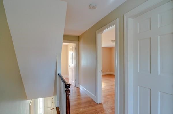77 West Central Street Natick, MA 01760 - Photo 17 of 22 a view of a hallway with wooden floor and staircase