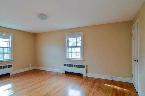 77 West Central Street Natick, MA 01760 - Photo 19 of 22 a view of an empty room with wooden floor and a window