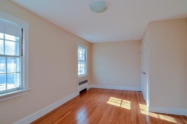77 West Central Street Natick, MA 01760 - Photo 20 of 22 an empty room with wooden floor and windows