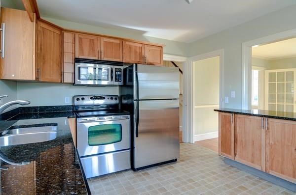 77 West Central Street Natick, MA 01760 - Photo 6 of 22 a kitchen with stainless steel appliances granite countertop a refrigerator a stove a sink and a microwave