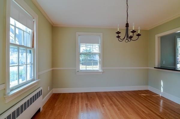 77 West Central Street Natick, MA 01760 - Photo 10 of 22 a view of an empty room with wooden floor and a window