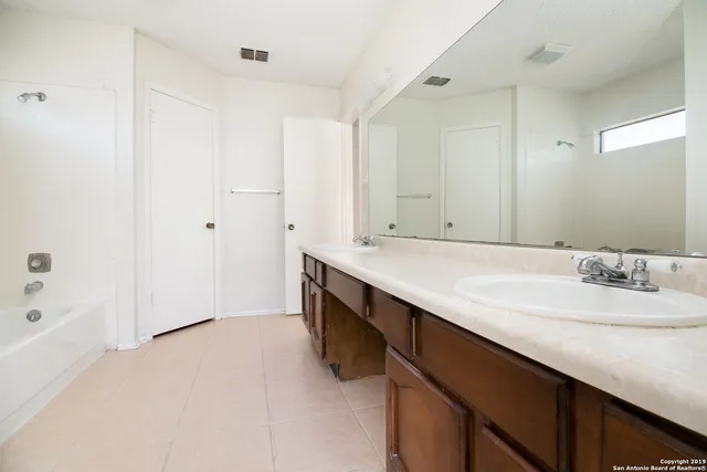 a bathroom with a double vanity sink a and mirror