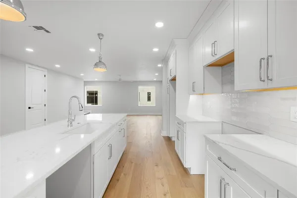 a spacious bathroom with a sink and a mirror