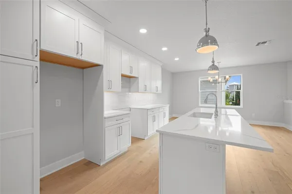 a kitchen with kitchen island a sink stainless steel appliances and cabinets