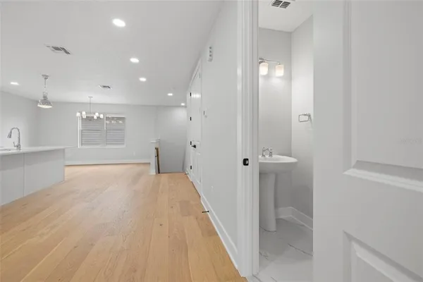 a view of a big room with wooden floor and windows