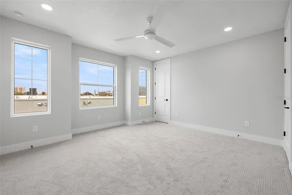 an empty room with windows and closet