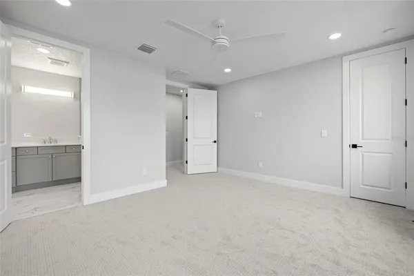 an empty room with a bathroom and a sink