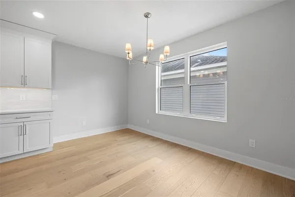 a view of an empty room with window and cabinet