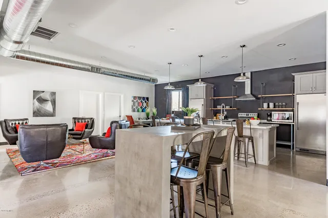 a view of a dining room with furniture floor to ceiling window and wooden floor