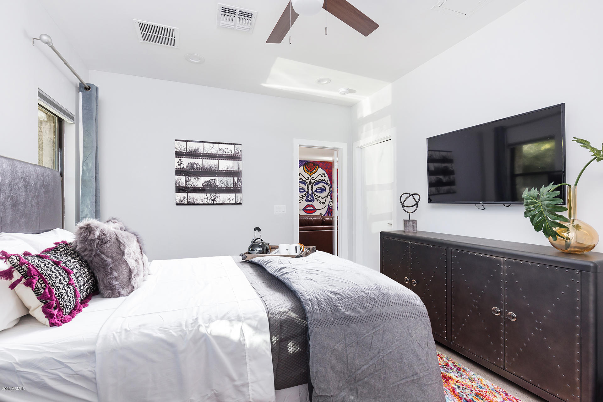 7505 East Main Street, Unit A Scottsdale, AZ 85251 - Photo 15 of 30 a bedroom with a bed and a flat screen tv
