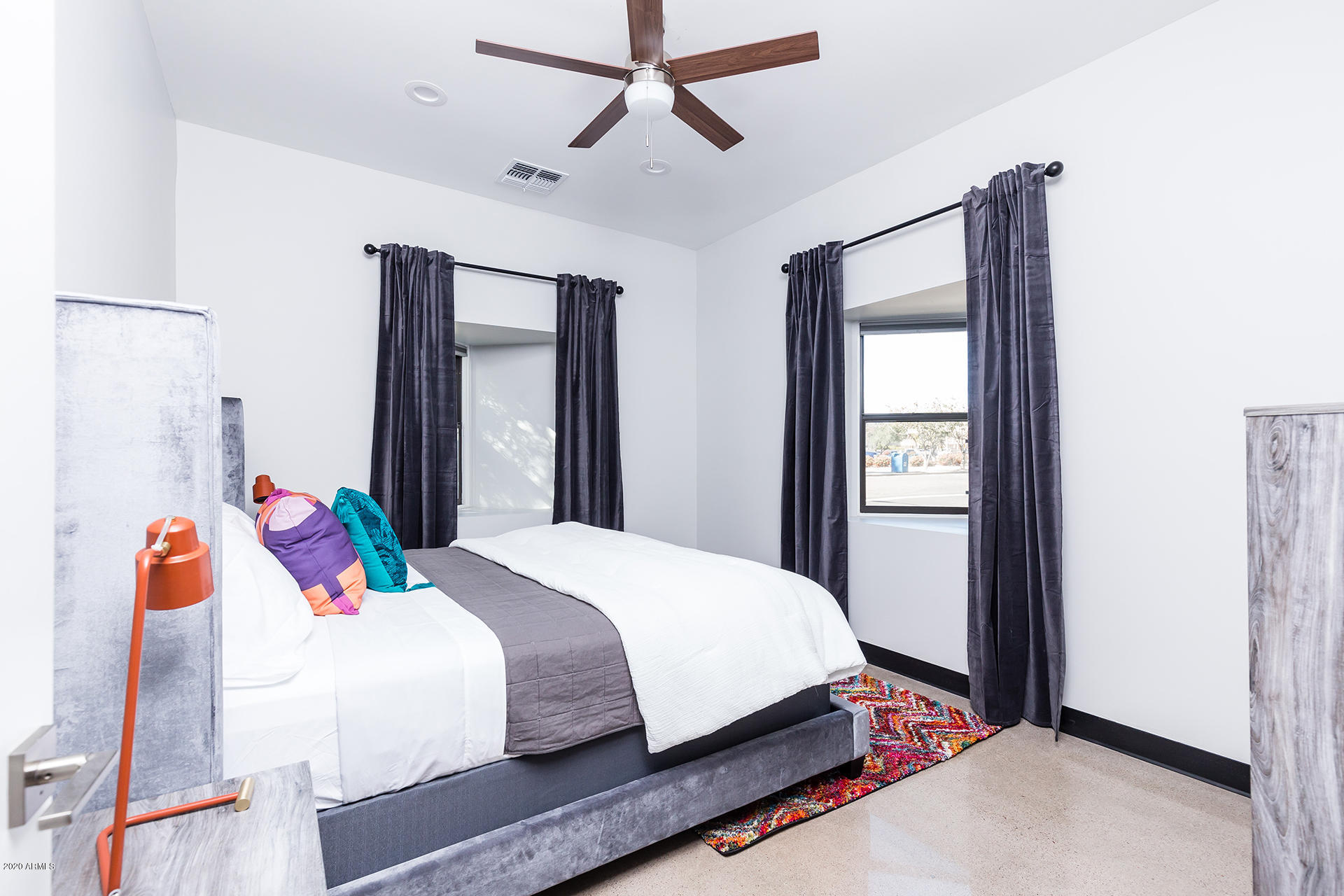 7505 East Main Street, Unit A Scottsdale, AZ 85251 - Photo 20 of 30 a bedroom with a bed and wooden floor