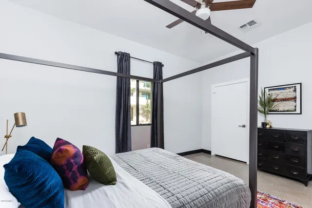 a bedroom with a bed and a dresser