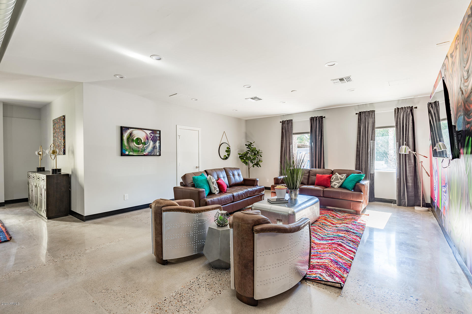 7505 East Main Street, Unit A Scottsdale, AZ 85251 - Photo 3 of 30 a living room with furniture and a flat screen tv